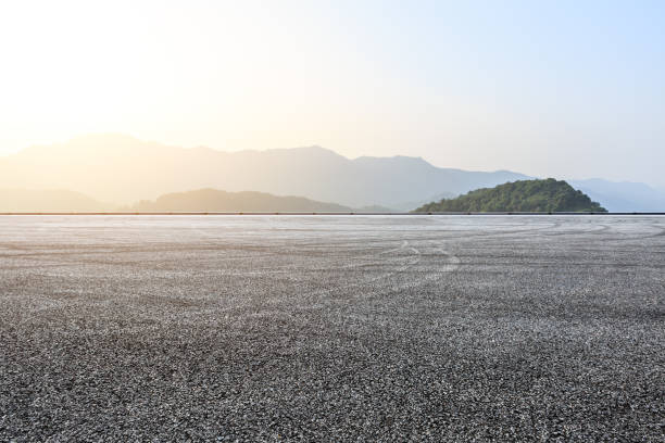 istock Asphalt race track ground and mountains landscape 1141566447