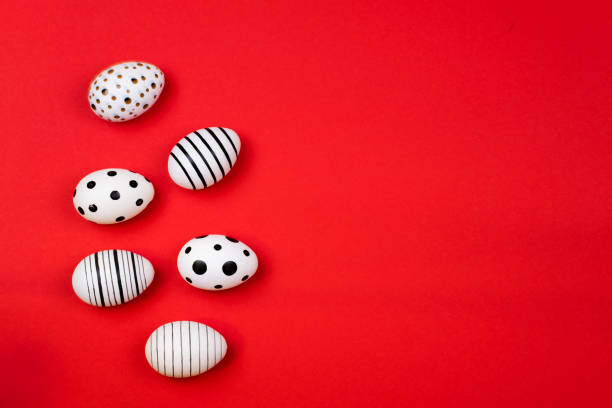 istock Different graphic hand-painted eggs on trendy coral background. 1141567432