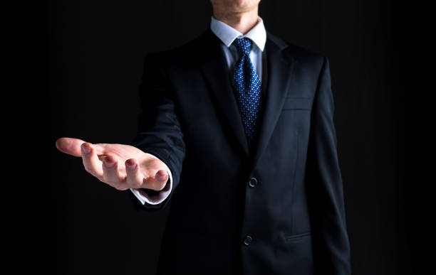 istock Man holding his hand out and showing something 1141567510