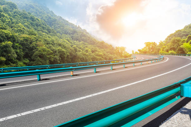 istock Asphalt road and mountains with blue sky at sunset 1141567608