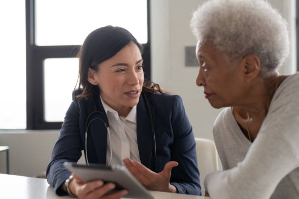 istock Young doctor with elderly patient 1141567646