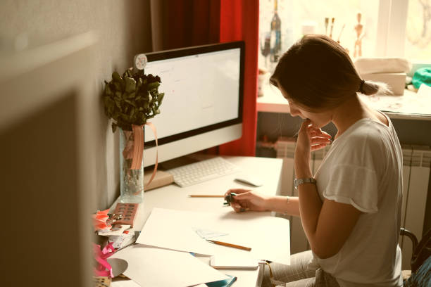 istock Girl sitting at the desk doing his geometry assignment 1141567711