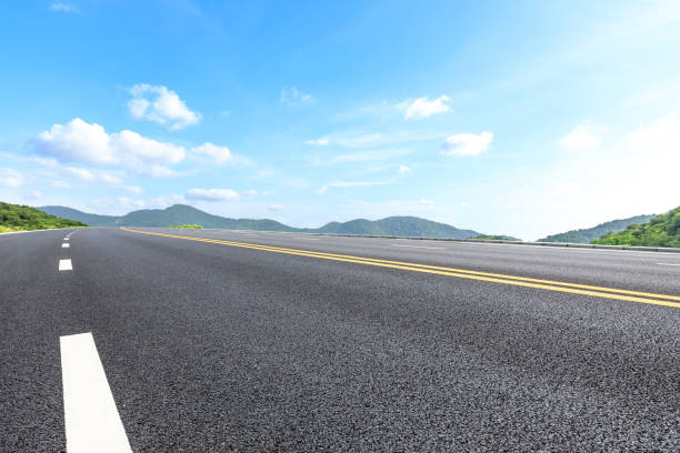 istock Asphalt road and mountains with blue sky on a sunny day 1141568085