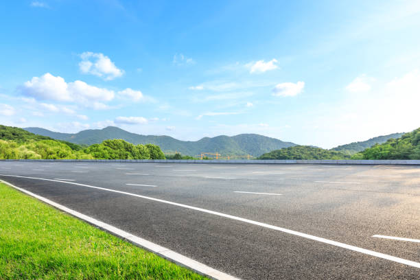 istock Asphalt road and mountains with blue sky on a sunny day 1141568638