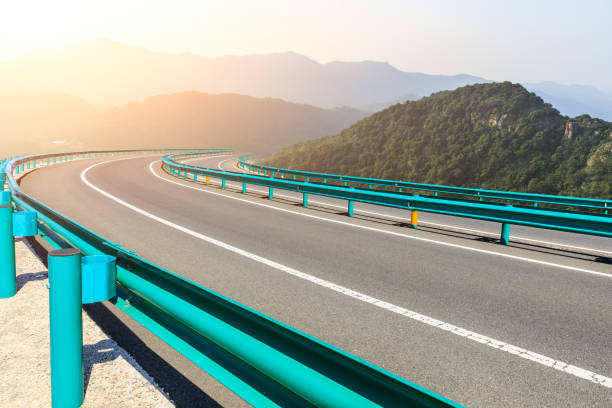 istock Asphalt road and mountains with blue sky at sunset 1141568687