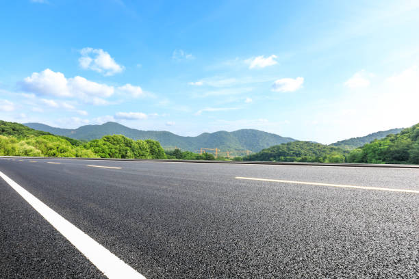 istock Asphalt road and mountains with blue sky on a sunny day 1141570310