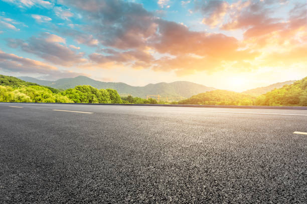 istock Asphalt road and mountains with blue sky at sunset 1141570432