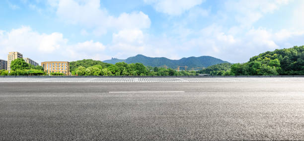 istock Asphalt road ground and mountains with blue sky on a sunny day 1141571143