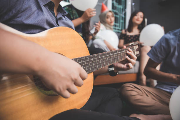 istock young happy friends singing together 1141571183