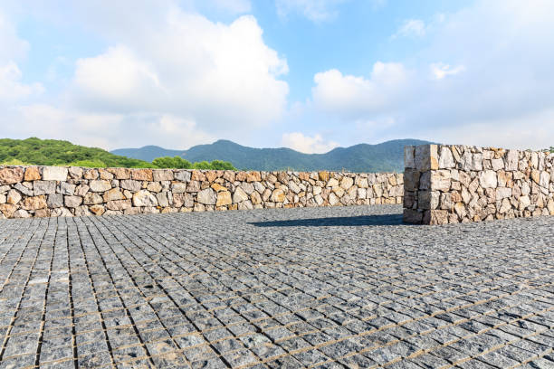 Rough square stone floor and green mountain with sky landscape