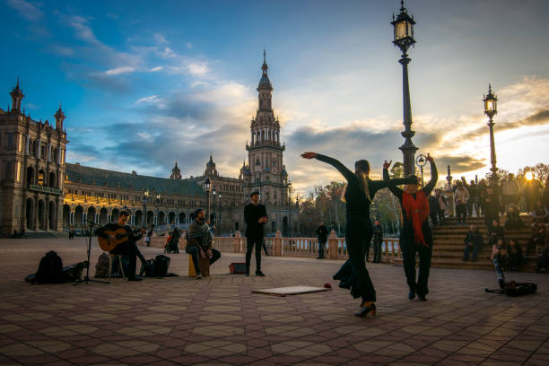 Flamenco Dancers-Spanish Steps-Seville-Andalusia-Spain-Flamenco Dancers-Plaza de España-Seville-Andalusia-Spain. Seville, Andalucia, Spain - January 08, 2018: Photo taken in the magnificent Plaza de España in Seville. In the image we see flamenco dancers and a local band. There are in the background several tourists enjoying the presentation that very well portrays the Spanish culture. flamenco photos stock pictures, royalty-free photos & images