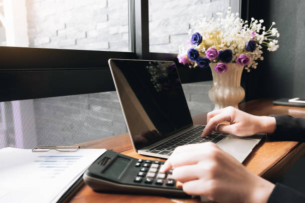 istock Business using laptop computer  with calculator on office desk. 1141574859