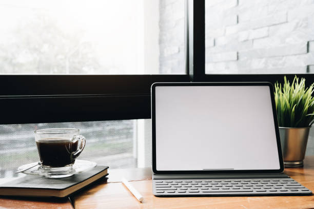 istock Modern desk table with notebook,laptop, and cup of coffee.Top view with copy space. 1141574872