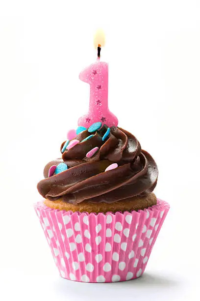 Photo of A birthday cupcake with the number one and chocolate icing