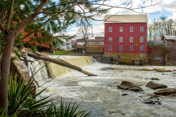 A grist mill along a water fall A water fall is in front of a grist mill in Indiana. indiana covered bridge stock pictures, royalty-free photos & images
