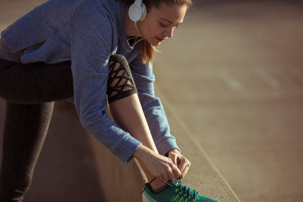 istock Woman Tying Shoelaces 1141579606