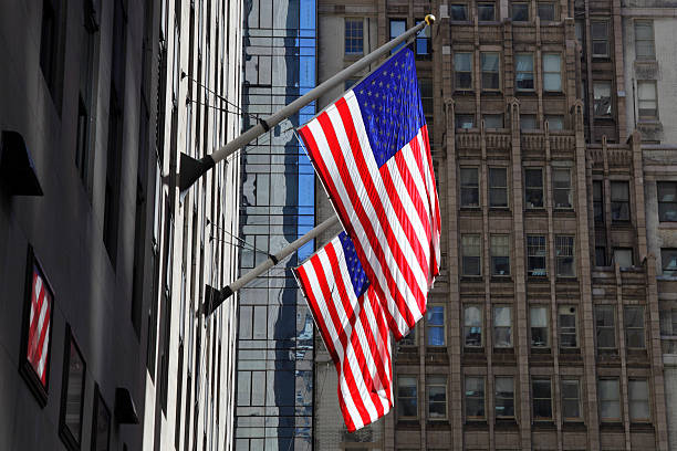 istock american flags in front of a skyscraper 114158102