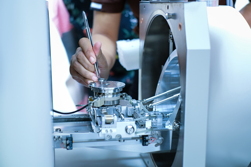 Scientist is preparation of nanomaterials for Scanning Electron Microscope (SEM) machine in laboratory
