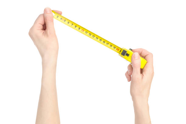 istock Hands are measuring something by measuring tape tool. Isolated on white. 1141585941