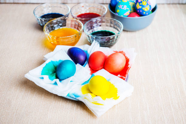 istock Easter eggs in plates with food color, decorating Easter eggs 1141586717