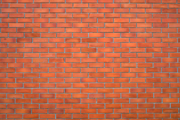 istock Red brick wall fragment background or brick layer building texture. 1141588613