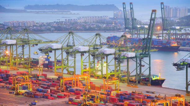 istock Logistics and transportation of Container Cargo ship and Cargo with working crane bridge in shipyard at sunrise, logistic import export and transport industry background 1141590059