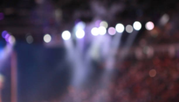 istock Blurred Concert light with colored spotlights and smoke. 1141590920