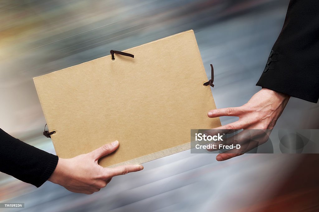 File Relay Two persons exchanging a file as a relay baton. File Folder Stock Photo