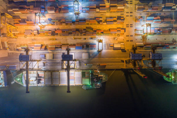 istock Logistics and transportation of Container Cargo ship and Cargo with working crane bridge in shipyard at sunrise, logistic import export and transport industry background 1141594306