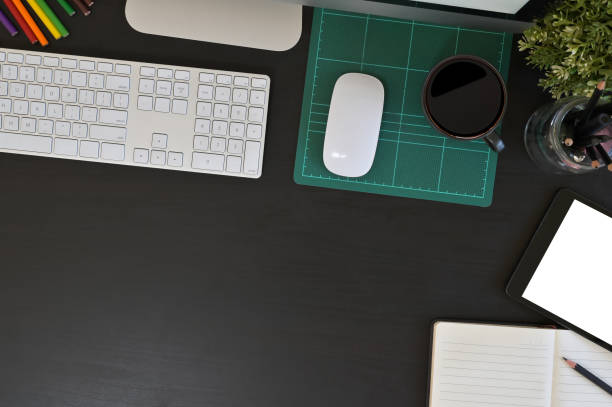 istock Creative desk workspace with mockup tablet computer and office equipment on black table, top view. 1141594510