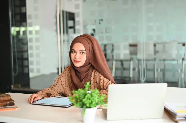 istock Islam woman working with digital tablet and pen on office workplace. 1141594536
