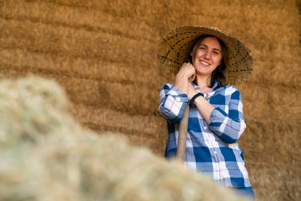 istock Farmers working with hay in barn 1141594709