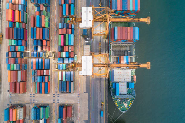 istock Logistics and transportation of Container Cargo ship and Cargo with working crane bridge in shipyard at sunrise, logistic import export and transport industry background 1141595286