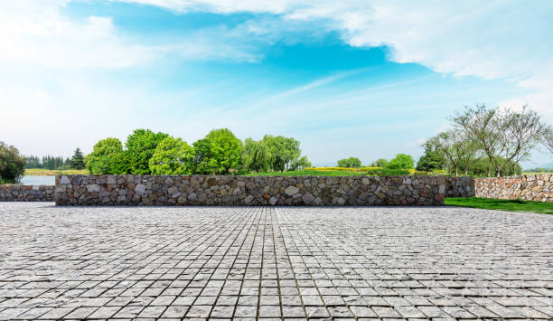 istock Rough stone floor and green woods with sky background 1141602935