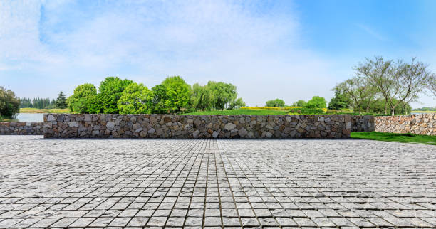 istock Rough stone floor and green woods with sky background 1141603170