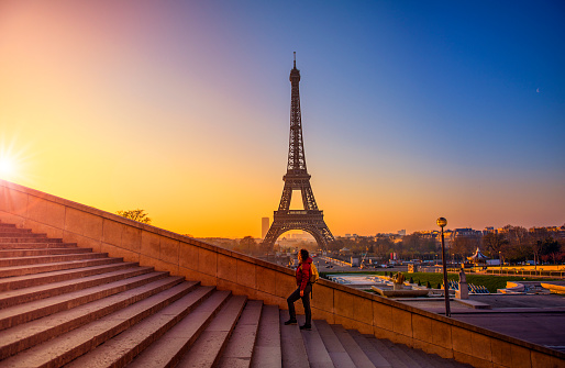 Beautiful young woman walking at Eiffel Tower, Paris.
