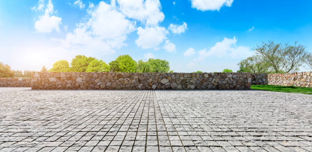 istock Rough stone floor and green woods with sky background 1141603352