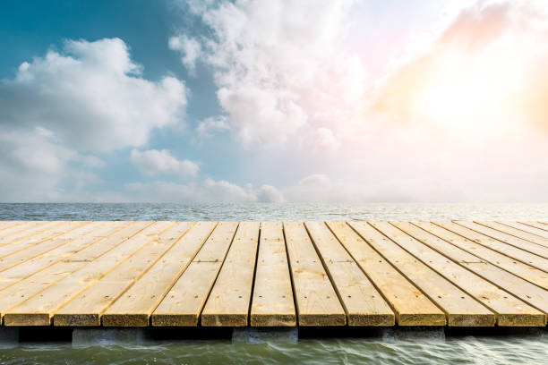 istock Wooden floor platform and blue sea with sky background 1141603533