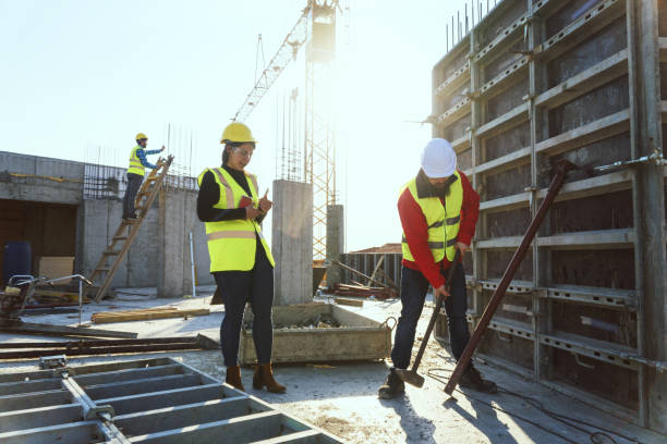 istock Meeting of a Confident Female Architect Holding a Digital Tablet and a Construction Worker Discussing and Working Together at Construction site of a Residential Building on a Bright Sunny Day. 1141603549