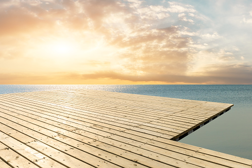 Wooden floor platform and blue sea with sky natural background