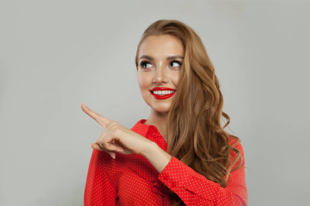 istock Perfect young model woman smiling and pointing finger 1141606539