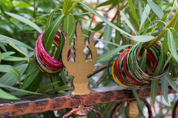 Photo of Colorful bangles, bracelets hanging on tree at Sri veeramakaliamman temple, Singapore