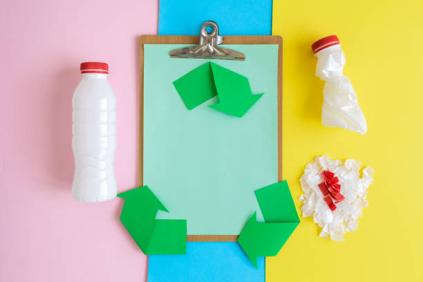 istock Clipboard with arrows recycling process icon and plastic disposable bottles abstract on multicolored pastel background. 1141610080