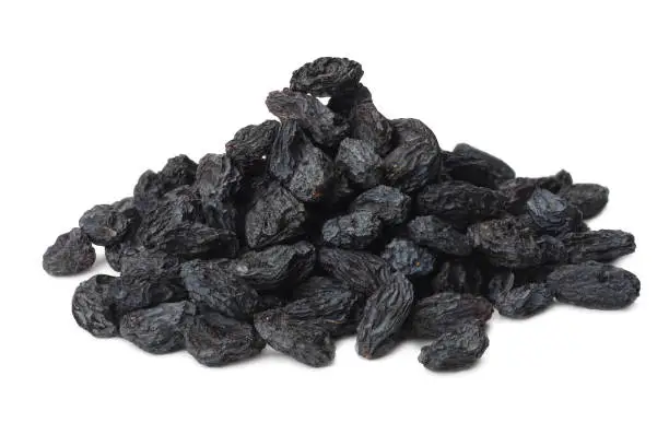 Photo of black raisins isolated on a white background