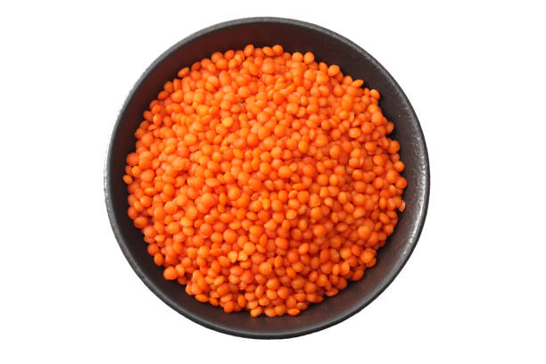 istock red lentils in black bowl isolated on white background. Top view. 1141612556