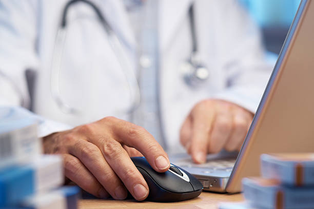 Doctor preparing online internet prescription stock photo