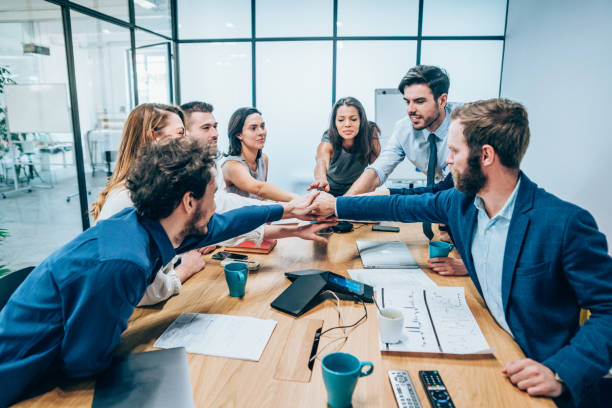 istock Business people stacking hands in conference room 1141615953