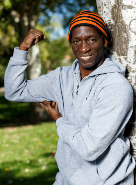 istock Athletic african  american male standing  near tree before training in park 1141617882