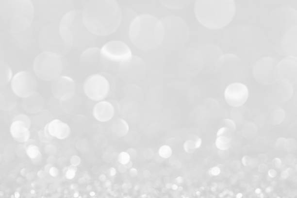 istock Silver white glittering Christmas lights. Blurred abstract background. 1141617893