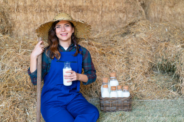istock Farmers working with hay in barn 1141618415